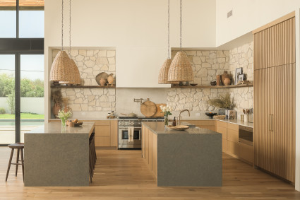 Earth-toned kitchen with two islands and a rock backsplash