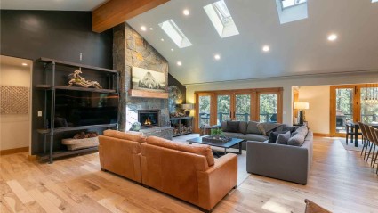 Modern mountain living room with vaulted ceilings and skylights