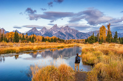 Man hiking along the river in Grand Teton National Park.