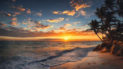 The sun sets at a Maui beach, one of the best vacation spots for couples.