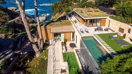 A cantilevered home by the coast home with a putting green and infinity pool