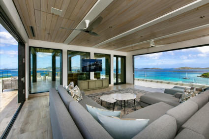 Living room with two open doors overlooking the ocean