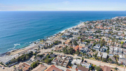 Aerial view of homes along the Pacific Ocean.