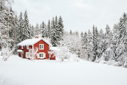 Red wood cabin in snow