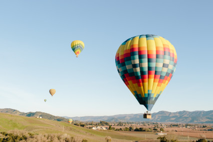 hot air balloons over hills