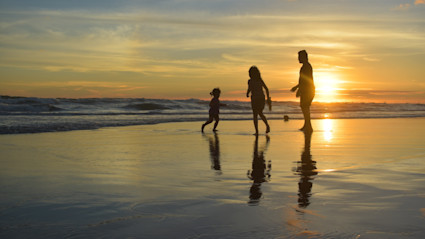 Silhouette of family at the ocean