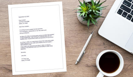 An example letter of explanation sits on a desk next to a coffee cup and laptop.