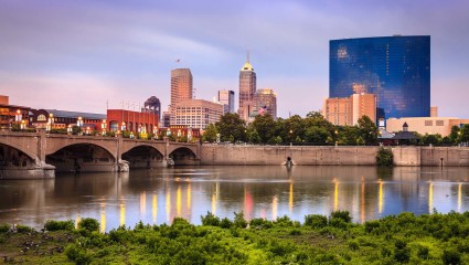 A scenic shot of Indianapolis captures the downtown area from the river, a hot spot for pet-friendly vacations.