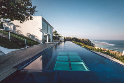modern home with infinity pool overlooking ocean