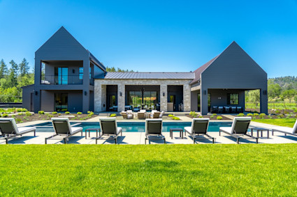 Bennett exterior pool area with the rear of the home.