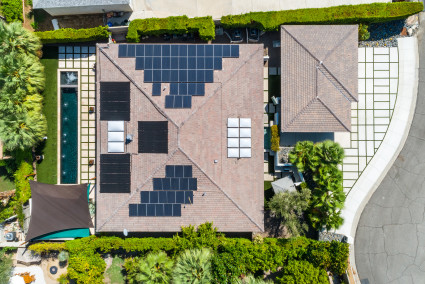 Aerial view of a home with roof-mounted solar panels