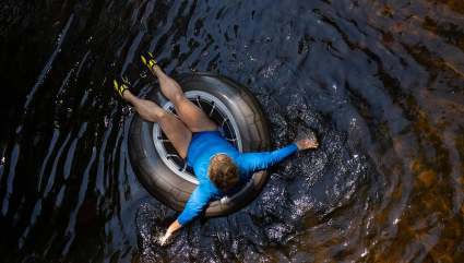 A person floats in a tire down the Yampa River, one of the top Steamboat Springs summer activities.