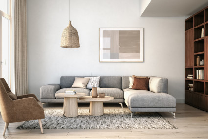 A living room with neutral colors and lots of texture is decorated in a Scandinavian style, a popular type of interior design.
