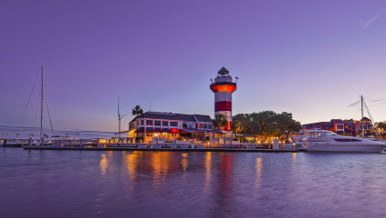 A lighthouse and oceanfront buildings fill Hilton Head Island, South Carolina, embodying why it’s one of the best places for a second home.