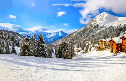 A ski run winds through on-mountain accomodations