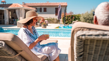 A couple spends time by the pool, living in one of the best countries to retire in.