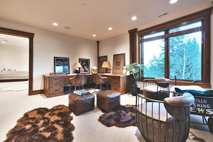 Office with brown furniture and a view of trees