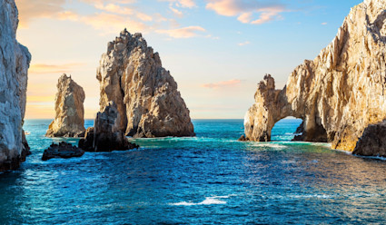 A large granite rock formation above the ocean.