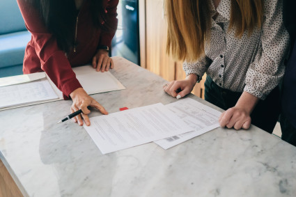 signing documents with two people