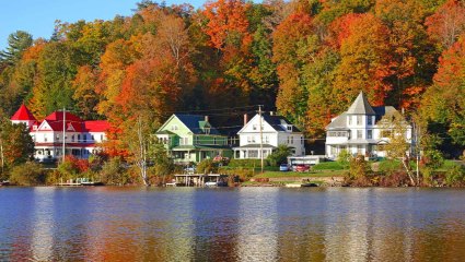 Quaint houses sit near the water of Lake Placid, one of the many great places to visit for pet-friendly vacations.