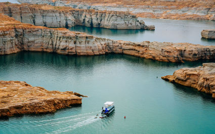 Lake Powell sits largely unoccupied under the setting sun, one of the best spring break ideas for families.