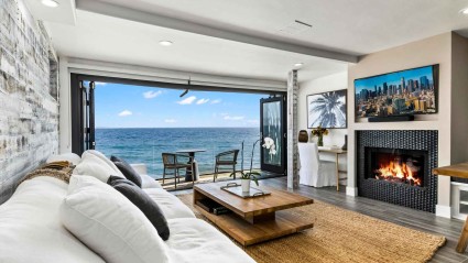 A cozy second home living room with a fireplace and a breathtaking view of the ocean