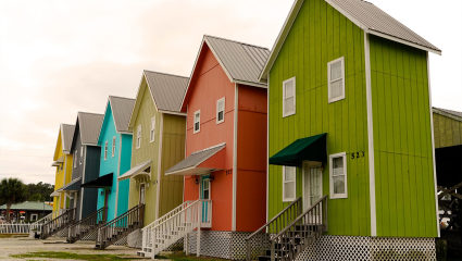 Brightly colored houses populate the streets of Dauphin Island, Alabama, embodying why it’s one of the best places for a second home.