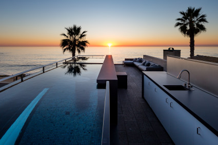 rooftop deck with pool and view of ocean