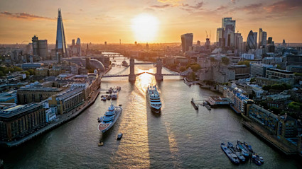 The sun sets over the Thames River, alluding to the topic of the 15 best places to live in London.