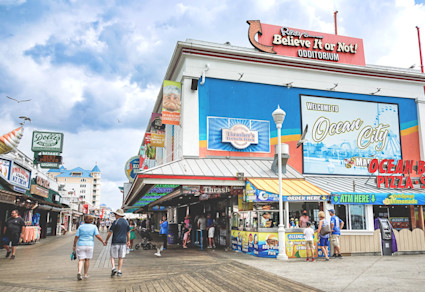 A bustling view of the vibrant boardwalk in Ocean City, Maryland, a popular destination among the best beach towns on the East Coast.