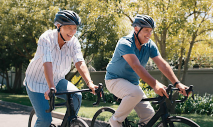 Image of a retired couple biking.