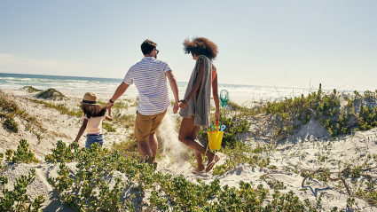 A family on a beach enjoying one of the many spring break ideas for families.