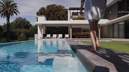 thumbnail for brand video - woman walking by pool