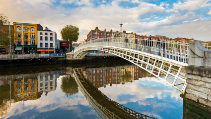 Couples cross a bridge in Dublin, one of the best vacation spots for couples. 