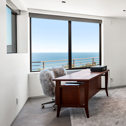 Brown desk with ocean through the window