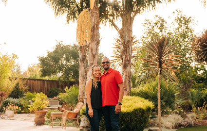 Kirk and Sheray standing under a palm tree