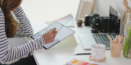 image women using tablet at her desk