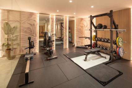 Small indoor gym with weights and an exercise bike