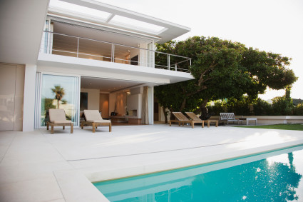 Modern house and patio next to swimming pool