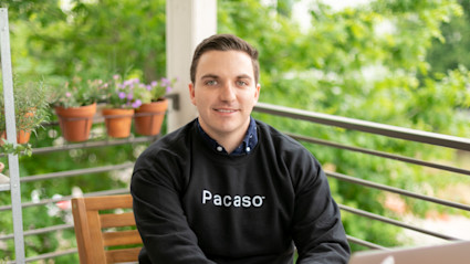 Lucas Roy on balcony with Pacaso sweatshirt