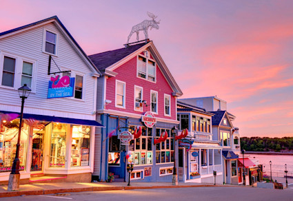 Lively scene of bars and restaurants lining the main strip in Bar Harbor, a charming northeast beach town.