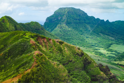 A photo of Mount Waialeale serves as the backdrop to mountain getaways on Kaua’i, Hawai’i. 