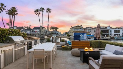 Outdoor patio with grill, seating, fire pit and a private dock in Newport Beach