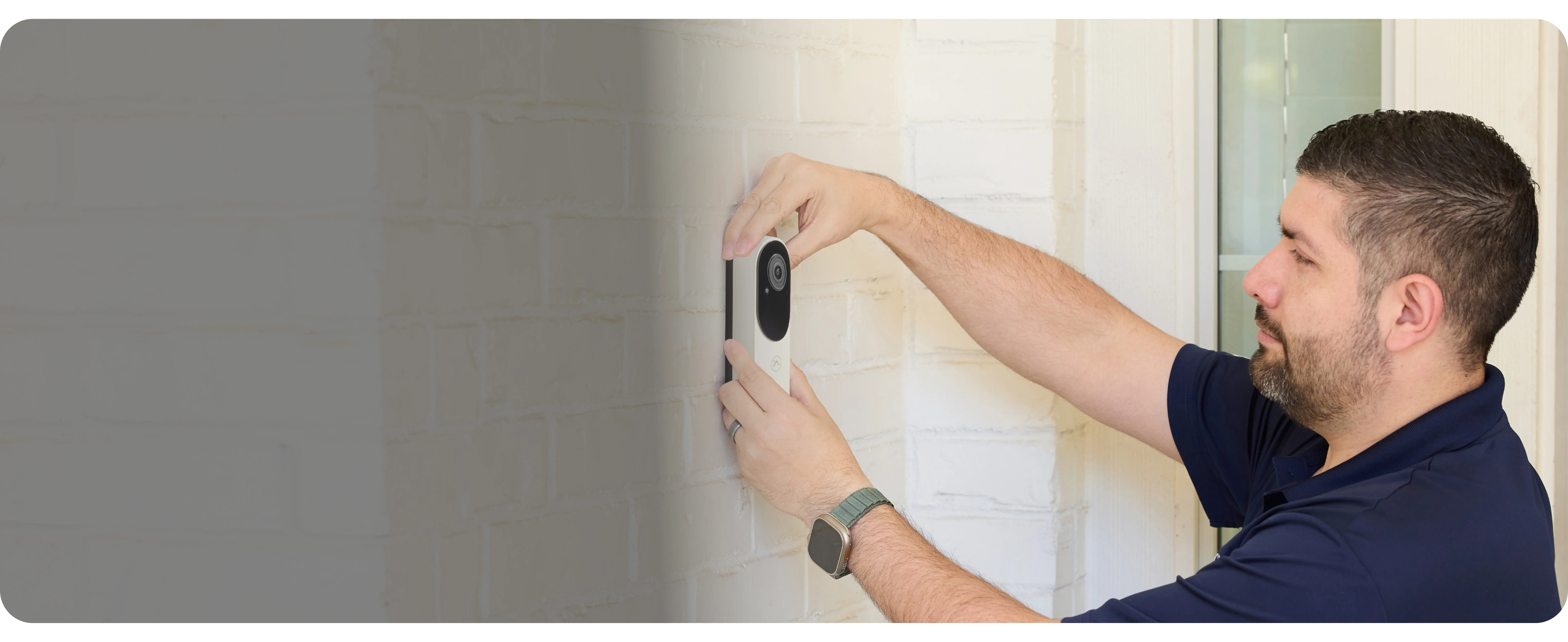 Brinks Home technician installing a video doorbell camera at the front of a home