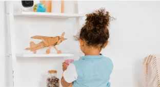 Girl putting a jar on a shelf