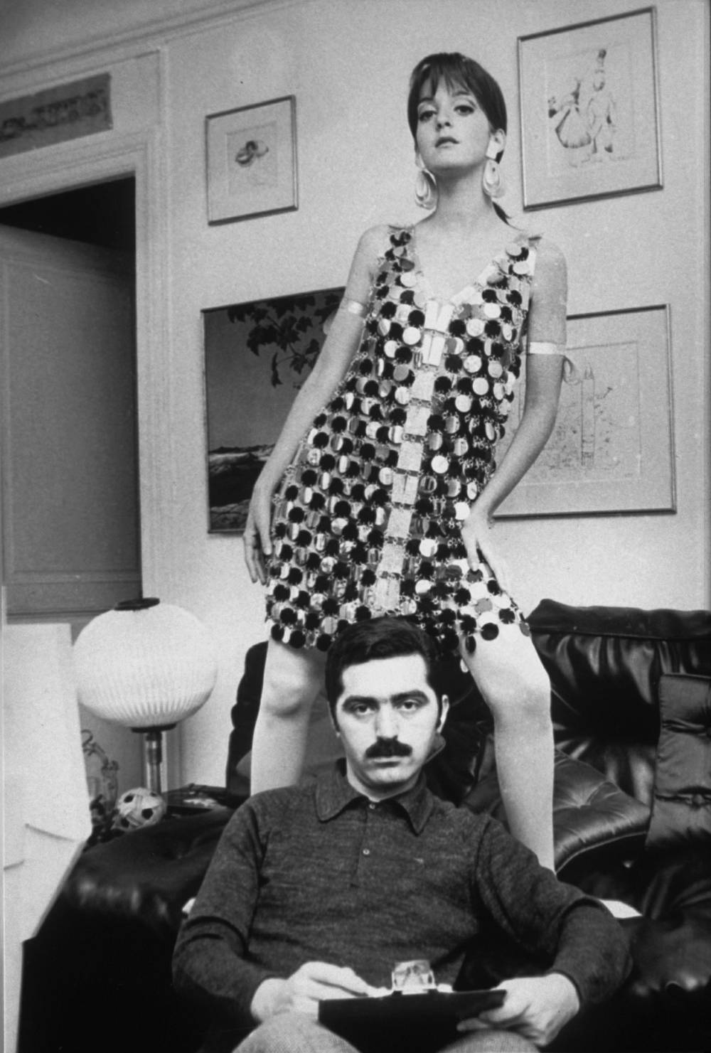  Portrait , Paco Rabanne with a model in one of his link dresses, 1966 