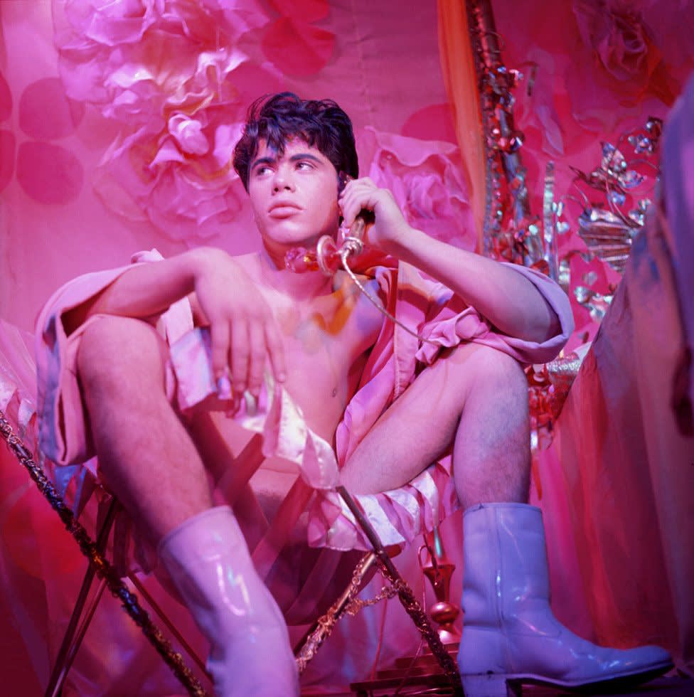 Bobby kendall seated in chair holding phone from    pink narcissus   