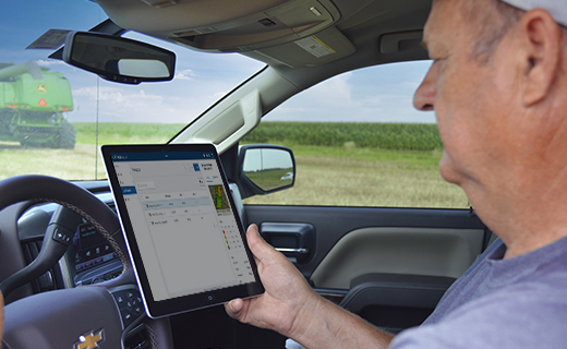 A farmer accesses his Trimble Ag Software data on a tablet in his truck.
