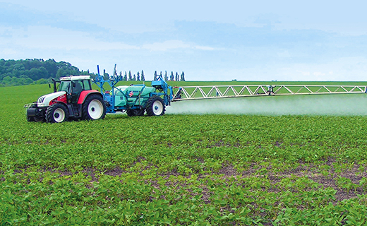A farmer uses Trimble's Field-IQ ISOBUS liquid control for spraying activities.
