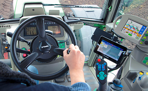 A farmer uses the Trimble GFX-350 display with EZ-Pilot steering system.
